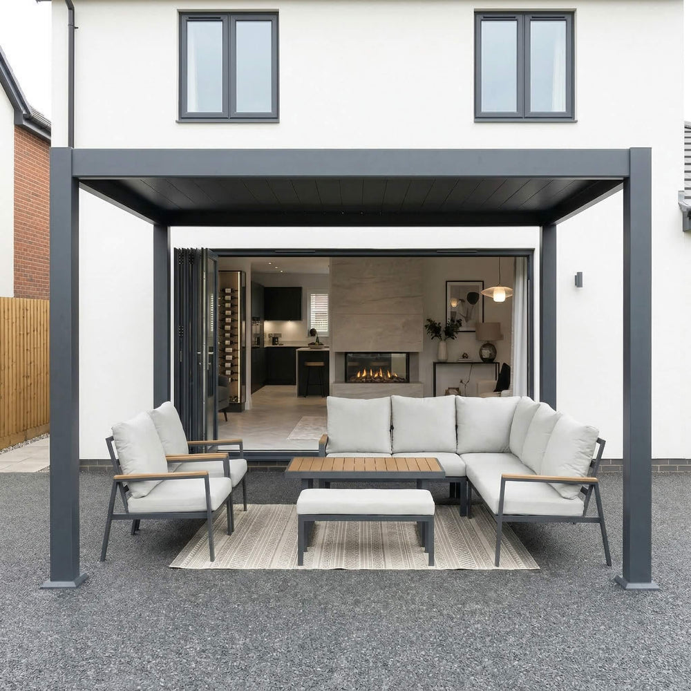 Meridian aluminium louvred pergola in Graphite Grey over an outdoor dining area