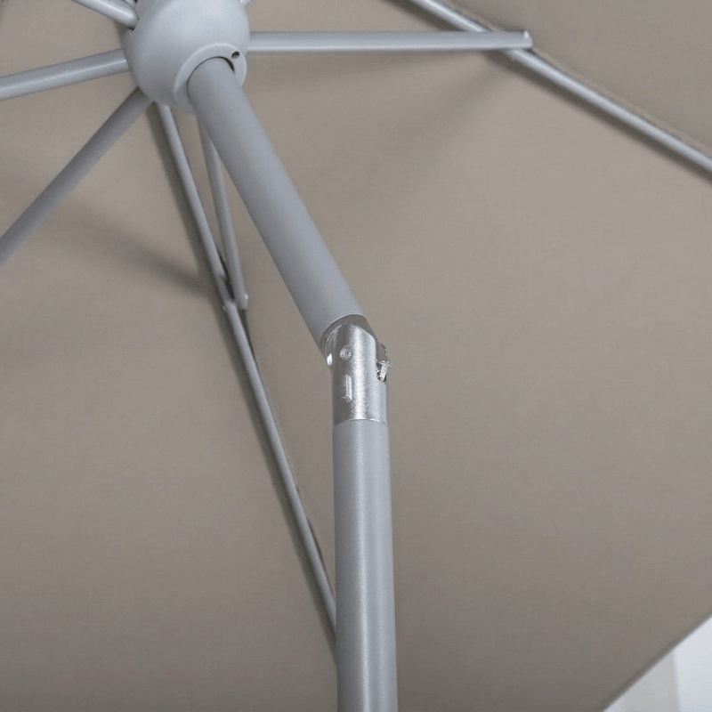 Close-up detail of a taupe patio umbrella frame showing the canopy attachment point and metal joint against a beige background.