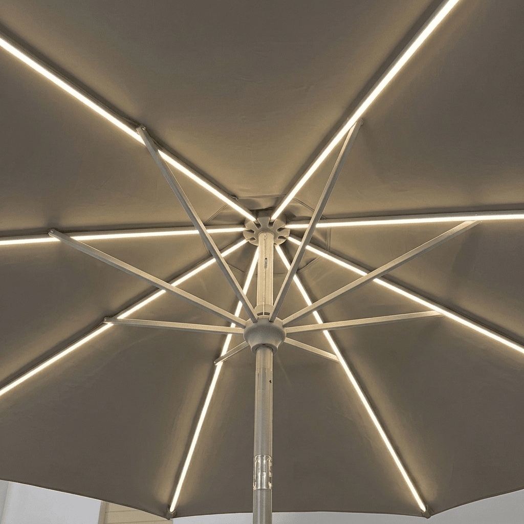 An overhead view of a patio umbrella with integrated LED strip lights running along the canopy and radiating along the metal ribs.