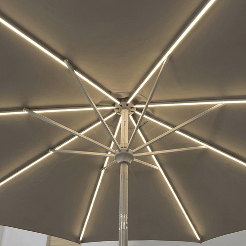 An overhead view of a patio umbrella with integrated LED strip lights running along the canopy and radiating along the metal ribs.