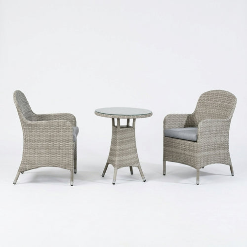 A 3-piece outdoor patio furniture set featuring two armchairs with gray cushions and a small round table, all made of woven gray wicker on a white studio background.