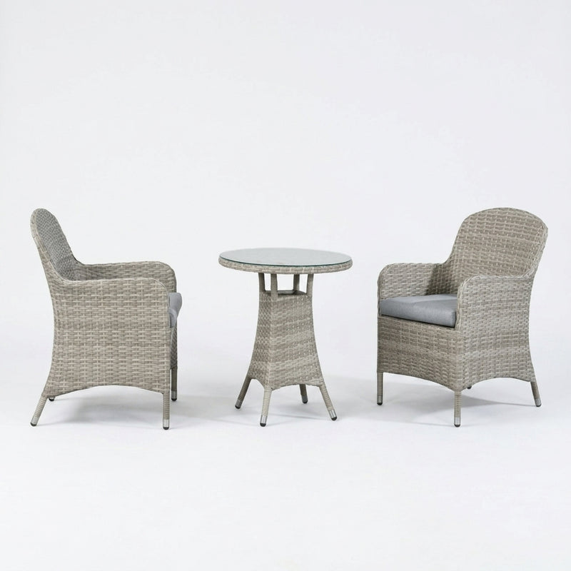 A 3-piece outdoor patio furniture set featuring two armchairs with gray cushions and a small round table, all made of woven gray wicker on a white studio background.