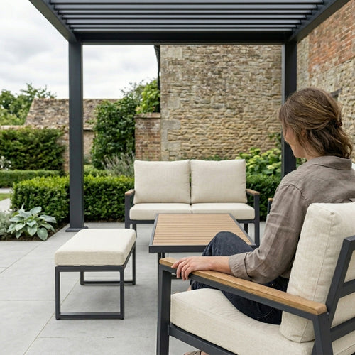 Person sitting on outdoor furniture set in a garden setting