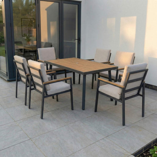 Outdoor dining set with a wooden table and chairs on a patio.