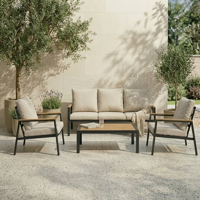 Outdoor patio set with sofa, chairs, and coffee table on a stone patio.
